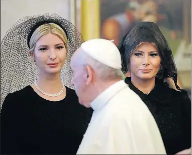  ?? [ALESSANDRA TARANTINO/THE ASSOCIATED PRESS] ?? Pope Francis walks past Ivanka Trump, left, and first lady Melania Trump at the Vatican on Wednesday. The women were following long-standing protocol that women who have an audience with the pope must wear long sleeves, formal black clothing and a veil...