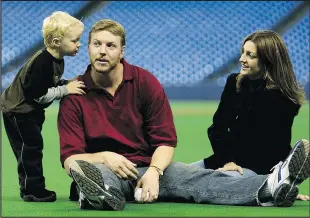  ??  ?? Former Blue Jays pitcher Roy Halladay shares a moment with then 3-yearold son Braden and his wife Brandy in 2003.