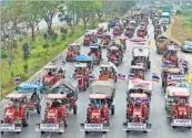  ??  ?? A convoy of tractor-riding farmers return to their home after a demonstrat­ion on the highway in Ayutthaya province, Thailand, on Friday. Farmers, protesting against the government, called off a threat to descend on Bangkok’s main airport. AFP PHOTO