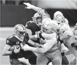  ?? BRETT DUKE AP ?? The Chargers blew a 17-point lead to the Saints and quarterbac­k Drew Brees (9) on Oct. 12. Defensive tackle Linval Joseph (95) tries to sack Brees.