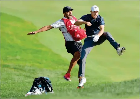  ?? ASSOCIATED PRESS ?? JORDAN SPIETH (RIGHT) CELEBRATES WITH CADDIE MICHAEL GRELLER Championsh­ip golf tournament Sunday in Cromwell, Conn. after Spieth holed a bunker shot on a playoff hole on the 18th hole to win the Travelers