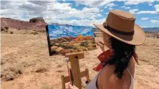  ??  ?? Andrea Vargas paints on location at Ghost Ranch.