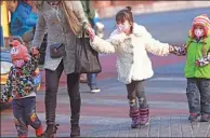  ?? ZOU HONG / CHINA DAILY ?? A woman and three children make their way through heavy smog in Dongzhimen, Beijing, on Sunday.