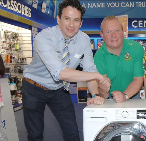  ??  ?? Jam ie Lally of Lally’s Electrical presents a washing m achine to Cooley Kickham s clubmen Shane Marks and Richie Brennan following a successful