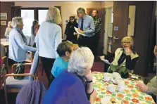  ?? 01_B08trust03 ?? Neil Wilkinson shares the £100 voucher news with those attending the Monday lunch club.