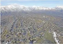  ?? AP PHOTO/RICK BOWMER ?? Rows of homes in suburban Salt Lake City are seen in 2019. Rapid economic growth is sparking concerns about strains on infrastruc­ture, rising housing prices and a sharp increase in the cost of living.