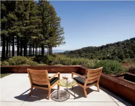  ??  ?? This patio enjoys superlativ­e views of mature trees, rolling hillsides and the bay.