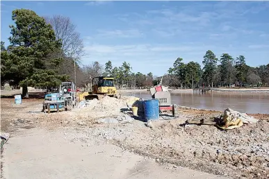  ?? Staff photo by Karl Richter ?? Constructi­on equipment sits idle Thursday beside the Spring Lake Park pond in Texarkana, Texas. A project to dredge the pond and reinforce its edges with stone is near completion, but recent frigid weather has delayed progress.