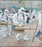  ?? REUTERS ?? Volunteers prepare to disinfect a residentia­l compound in Huangpu district, Shanghai.