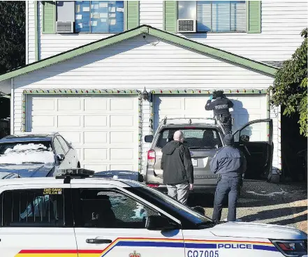  ?? NICK PROCAYLO ?? Port Coquitlam police probe the aftermath of a drive-by shooting in the 3800-block Ulster Street Monday. The incident occurred Sunday night. No one was hurt.