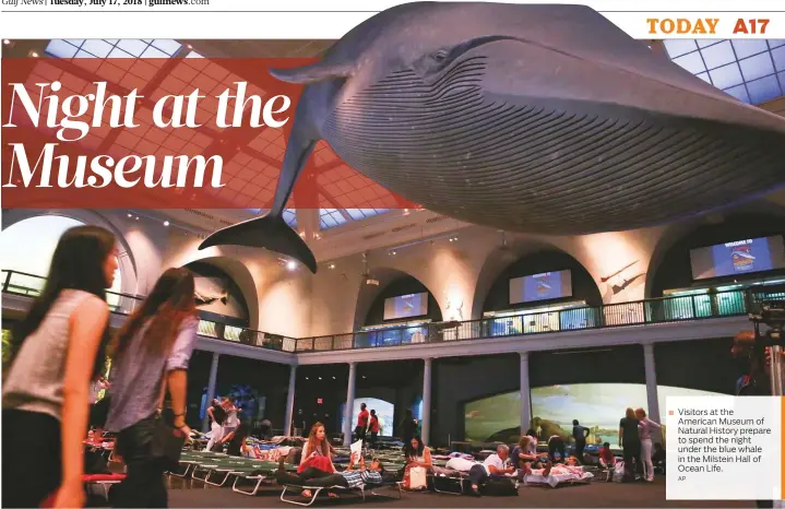  ?? AP ?? Visitors at the American Museum of Natural History prepare to spend the night under the blue whale in the Milstein Hall of Ocean Life.