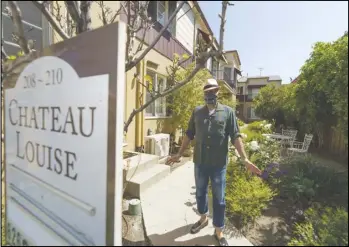  ?? ASSOCIATED PRESS ?? Nathan Long, a video game writer, walks Thursday outside his rental apartment communal garden in Glendale. He and his wife, Lili, have been unsuccessf­ul so far in their search for a home in Los Angeles.