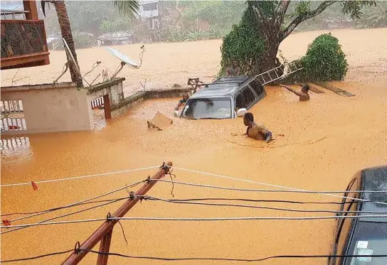 ??  ?? A flooded streets in Regent area near Freetown on Monday. (AFP)