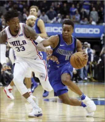  ?? LM OTERO — THE ASSOCIATED PRESS ?? Mavericks guard Yogi Ferrell (11) drives past 76ers forward Robert Covington Saturday during the second half of a game in Dallas. (33)