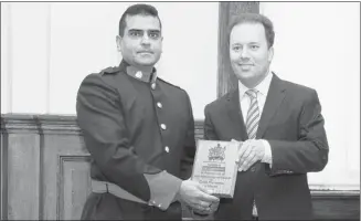  ?? Stuart Gradon, Calgary Herald ?? Const. Charanjit Meharu, left, of the Calgary Police Service, with Jonathan Denis, Alberta’s justice minister and solicitor general. Meharu received a Crime Prevention Award for making the streets safer.