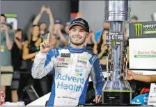  ?? CHUCK BURTON/AP PHOTO ?? Kyle Larson poses with the trophy after winning the NASCAR All-Star Race on Saturday at Charlotte Motor Speedway in Concord, N.C.