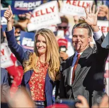  ?? ALYSSA POINTER/ AJC ?? Sens. Kelly Loeffler and David Perdue rally last month in Canton. Loeffler said Wednesday that “I’ll certainly look at supporting” the president’s desire to boost stimulus payments.