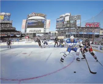  ?? AP PHOTOS ?? WHAT A DAY: Buffalo’s Sam Reinhart battles New York’s Brady Skjei for the puck during the first period of the Winter Classic yesterday at Citi Field in New York. Below, the Rangers celebrate in overtime after winning on a goal by J.T. Miller.