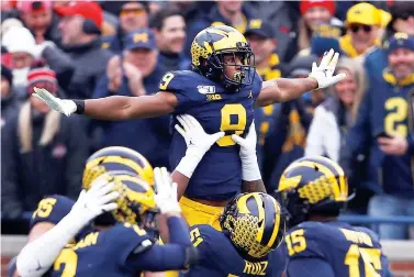  ?? AP Photo/Paul Sancya, File ?? ■ Michigan wide receiver Donovan Peoples-Jones (9) celebrates his 25-yard touchdown reception against Ohio State during the first half of an NCAA game Nov. 20 in Ann Arbor, Mich. Michigan canceled its annual rivalry game at Ohio State on Tuesday because of the COVID-19 outbreak within the Wolverines football program.
