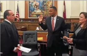  ?? DIGITAL FIRST MEDIA FILE PHOTO ?? President Judge Thomas M. DelRicci administer­s the oath of office to Ken Lawrence Jr. as Montgomery County commission­er as his wife, Jennifer, holds the Bible.