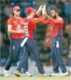  ?? — Reuters ?? England’s Adil Rashid celebrates with captain Eoin Morgan and Olly Stone after taking the wicket of Sri Lanka’s Dasun Shanaka (not pictured).