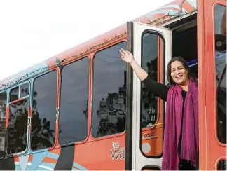  ?? Jon Shapley / Houston Chronicle ?? Lauren Barrash owns and operates The Wave, a fleet of eight bright orange jitney buses. The vehicles ferry people around the city, and the drivers add local color to the journeys.