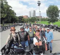  ?? RICK WOOD / MILWAUKEE JOURNAL SENTINEL ?? Ron Alghini of Libertyvil­le, Illinois, from the Lake Shore Harley Owners Group chapter, takes a group photo in Milwaukee after a three-hour ride.