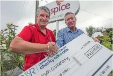  ?? PHOTO: DOUG FIELD/STUFF ?? Charity Bike Ride chairman Shane Brookland presents Hospice South Canterbury general manager Peter O’Neill with a cheque.