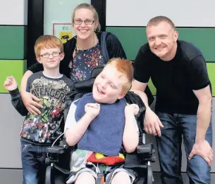  ??  ?? ●● Jake Brocklehur­st with his little brother Nathan, mum Lindsey and dad Pete, from Macclesfie­ld, leaving Ronald McDonald House