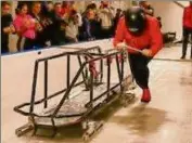  ?? Mike Kane / Special to the Times Union ?? Lauren Brzozowski of Wycoff, N.J., pushes the bobsled training sled on the new refrigerat­ed start track in the Mountain Pass Lodge at Mount Van Hoevenberg.