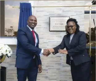  ?? ?? NMB Bank CEO Gerald Gore (left) and R Mushosho, who represente­d the RBZ deputy governor Dr Jesmen Chipika, shake hands after officially opening the bank’s new head office (pictured below) in Borrowdale, Harare.