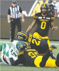  ?? PETER POWER/THE CANADIAN PRESS ?? Zach Collaros’s final play as a member of the Saskatchew­an Roughrider­s ended when he absorbed an illegal hit to the head from the Tiger-cats’ Simoni Lawrence on June 13.