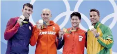  ??  ?? Joseph Schooling (third from left) with his Gold medal in the 100m Butterfly at the 2016 Rio Olympics where he beat his idol Michael Phelps who shared a three-way tie for the silver with Chad Le Clos of South Africa and Laszlo Cseh of Hungary