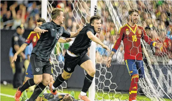  ?? SPORTSFILE ?? Sean St Ledger of Republic of Ireland celebrates a goal (subsequent­ly disallowed) with team-mate Simon Cox during the friendly against Spain at Yankee Stadium in June 2013, and (below) swapping jerseys with Italy’s Gianluigi Buffon after the Euro 2012 match in Poznan