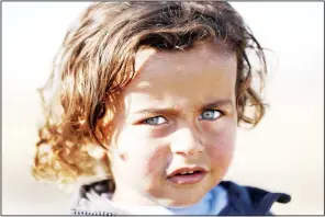  ??  ?? A displaced Iraqi boy, who fled the violence in the Iraqi northern city of Mosul as a result of a planned operation to retake the city from jihadists, poses on Dec 3 at Hasan Sham refugee camp, in the eponym
village, some 40 kms east of Arbil. (AFP)