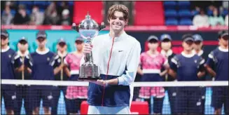  ?? ?? Taylor Fritz of the U.S. poses for a photo with his champion trophy during the award ceremony for the singles of the Japan Open tennis championsh­ips in Tokyo. Fritz beat Frances Tiafoe 7-6, 7-6. (AP)