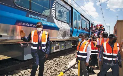  ?? Picture: Supplied. ?? ON THE MOVE. Gauteng premier David Makhura next to one of the new trains being built in Nigel.