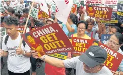  ?? AP ?? Filipinos rally outside the Chinese Consulate in Makati city, east of Manila, against the two-day state visit to the country of Chinese President Xi Jinping.