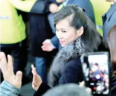  ?? — Reuters photo ?? Hyon Song Wol, head of North Korea’s Samjiyon Orchestra, waves to South Koreans as she arrives at a railway station in Gangneung, South Korea.