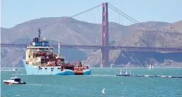 ??  ?? TRASH COLLECTOR – A ship tows The Ocean Cleanup’s first buoyant trash-collecting device toward the Golden Gate Bridge in San Francisco en route to the Pacific Ocean on Saturday, September 8. Once deployed, the boom will form a U-shaped barrier to trap plastic and trash that currently makes up the ‘Great Pacific Garbage Patch’. (AP)