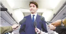  ?? AP-Yonhap ?? Canadian Prime Minister and Liberal Party leader Justin Trudeau makes a statement in regards to a photo coming to light of himself from 2001, wearing “brownface,” during a scrum on his campaign plane in Halifax, Nova Scotia, Wednesday.