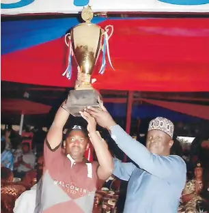  ??  ?? Patron of Jos Malcomines team and Tournament Manager, Murtala Laushi lifts high the Governor’s Cup after presentati­on by the Plateau State Commission­er for Youth &amp; Sports, Victor Lapang during the closing ceremony of the 2018 Jos Winter polo tournament in Jos last week.