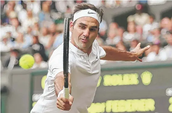  ?? | GARETH FULLER/ AP ?? Roger Federer, who lost to Novak Djokovic in the 2014 and 2015 Wimbledon finals, returns the ball Friday during his semifinal victory over Tomas Berdych.