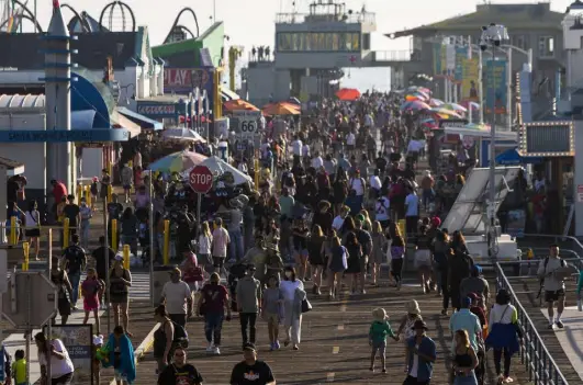  ?? Alisha Jucevic, © The New York Times Co. ?? Crowds at the pier in Santa Monica, Calif., on April 6. The most contentiou­s census in memory will also be the slowest to release detailed statistics for businesses and government­s to use. Blame it (partly) on the pandemic.