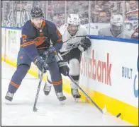  ?? Jason Franson The Associated Press ?? Oilers defenseman Evan Bouchard, left, and Kings left wing Quinton Byfield pursue the puck during Edmonton’s 4-1 win Thursday.