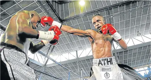  ?? Picture: MARK ANDREWS ?? CRUNCH FIGHT: Athenkosi Dumezweni and Lindile Tshemese exchange blows at Indoor Sports Centre in Mdantsane.