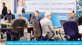  ?? — AFP ?? TEHRAN: Iranians register for the upcoming parliament­ary elections at the interior ministry in the capital yesterday.