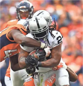 ?? RON CHENOY, USA TODAY SPORTS ?? Oakland running back Marshawn Lynch, tackled by Denver’s Von Miller (58) and Shaquil Barrett, has found little running room the past two weeks.