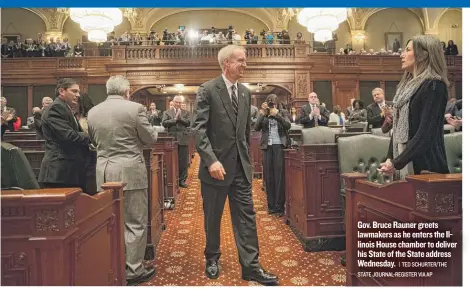  ?? | TED SCHURTER/ THE STATE JOURNAL- REGISTER VIA AP ?? Gov. Bruce Rauner greets lawmakers as he enters the Illinois House chamber to deliver his State of the State address Wednesday.