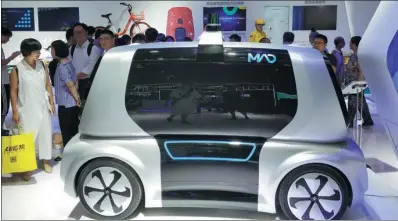  ?? ZHAO JUNCHAO / FOR CHINA DAILY ?? A Meituan Autonomous Delivery car, or MAD — a smart concept vehicle designed by Meituan-Dianping to boost its unmanned delivery service — is displayed at a high-tech exhibition in Chongqing.